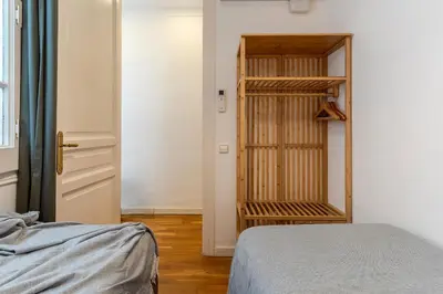 a bedroom with a bed and a book shelf at Canela Homes BARCELONA FIRA in Barcelona