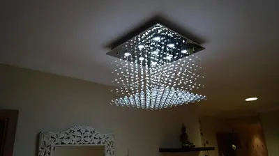 a chandelier with lights hanging from a ceiling at Good-Home Paseo de Gracia in Barcelona