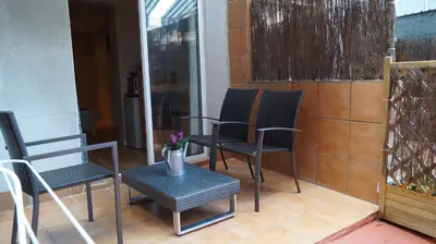 a pair of chairs and a table on a patio at Good-Home Paseo de Gracia in Barcelona
