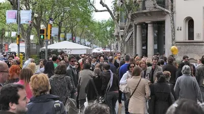 a large crowd of people walking down a city street at Good-Home Paseo de Gracia in Barcelona
