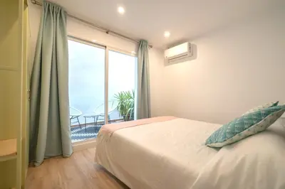 a bedroom with a bed and a large window at Soler Apartments in Sant Adria de Besos