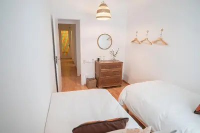 a bedroom with a bed and a dresser and a mirror at Stunning Designer 2 Bed Apt in Glorious Gràcia in Barcelona