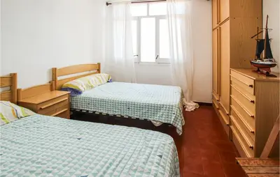 a bedroom with two beds and a window at 4 Bedroom Lovely Apartment In Cunit in Cunit
