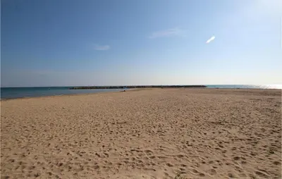 a beach with footprints in the sand and the ocean at 4 Bedroom Lovely Apartment In Cunit in Cunit