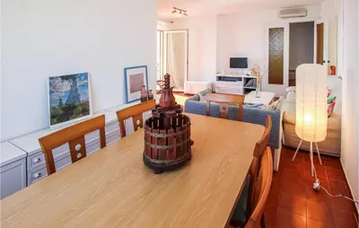 a living room with a table and a living room at 4 Bedroom Lovely Apartment In Cunit in Cunit