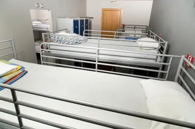 a room with three beds in a room at Alberg Sants Bcn in Barcelona