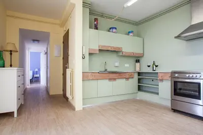 a kitchen with green and white cabinets and a stove at Stay U-nique Apartments Marina III in Barcelona