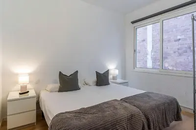 a bedroom with a large white bed and a window at 1690 - AB Eixample Rosselló in Barcelona