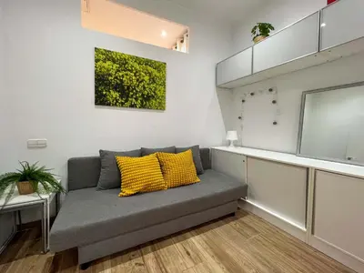 a living room with a gray couch and yellow pillows at Stay U-nique Apartments Caminal in Barcelona