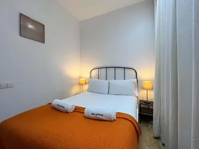 a bedroom with a bed with two towels on it at Stay U-nique Apartments Caminal in Barcelona