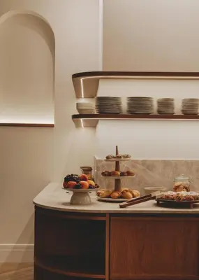 a counter with some pastries and plates of food at Casa Llimona Hotel Boutique in Barcelona