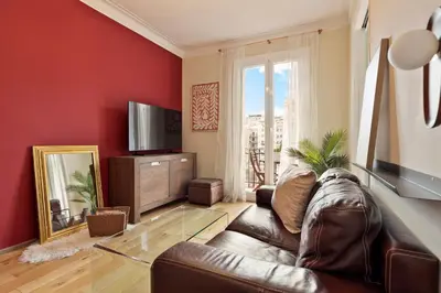 a living room with a leather couch and a mirror at Enjoy Apartments Donna in Barcelona