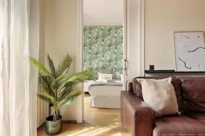 a living room with a couch and a plant at Enjoy Apartments Donna in Barcelona