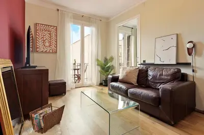 a living room with a leather couch and a glass table at Enjoy Apartments Donna in Barcelona