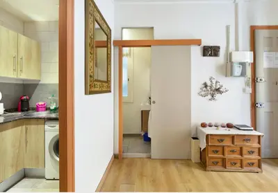 a kitchen with a door open to a kitchen with a sink at Great apartment in Sagrada Familia with Balcony in Barcelona