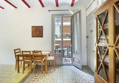 a dining room with a wooden table and chairs at Great apartment in Sagrada Familia with Balcony in Barcelona