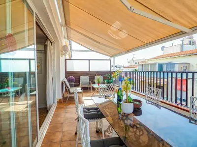 a balcony with a table and chairs on it at Sea and Sand Penthouse by Hello Homes Sitges in Sitges