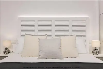 a white bed with white pillows and two lamps at Catalonia Square Terrace & 5 bathrooms 5BD-5BTH in Barcelona