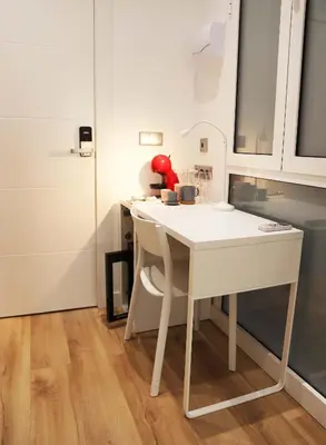 a kitchen with a white table in a room at Hostal Gràcia in Barcelona