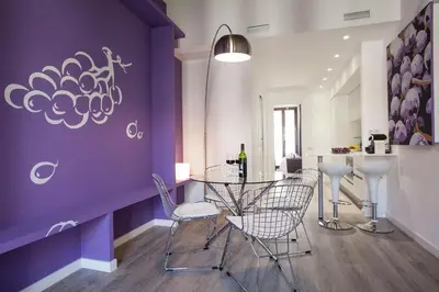 a dining room with purple walls and a table and chairs at Habitat Apartments ADN in Barcelona