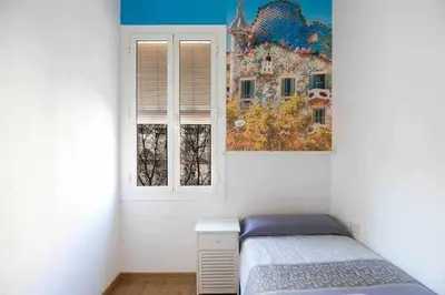 a small bedroom with a bed and a window at Consell Cent Apartment II 3 domitorios Eixample in Barcelona