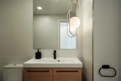 a bathroom with a white sink and a mirror at CATERINA Liceu in Barcelona