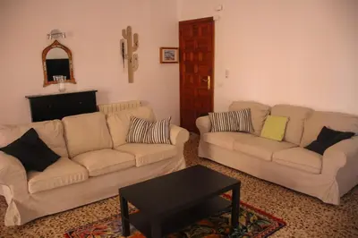 a living room with two couches and a table at Piso superior tranquilo terraza y vistas A 45 min de Barcelona in Cunit