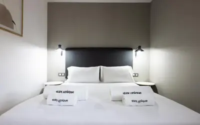 a bedroom with a white bed with two pillows at Stay U-nique Apartments Pau Claris II in Barcelona