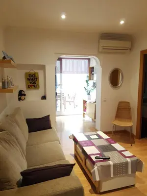 a living room with a couch and a table at Room in shared appartment close to Camp Nou in Hospitalet de Llobregat