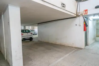 an empty parking garage with a car parked in it at HomeHolidaysRentals Bluemar-Costa Barcelona in Pineda de Mar