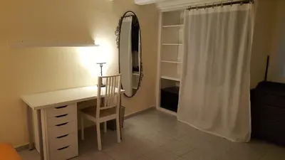 a desk with a mirror and a chair in a room at Apart 2 beds 1 sofabed downtown 31 nigths min Barcelona in Barcelona