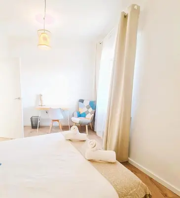 a bedroom with a bed with two towels on it at G74 AVENIDA GAUDI nice 4 bedrooms apartment with balcony with views of the Basilica Sagrada Familia in Barcelona