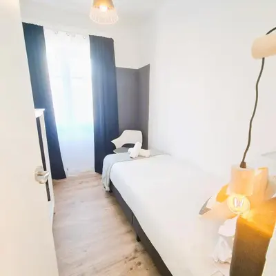 a bedroom with a white bed and a window at G74 AVENIDA GAUDI nice 4 bedrooms apartment with balcony with views of the Basilica Sagrada Familia in Barcelona