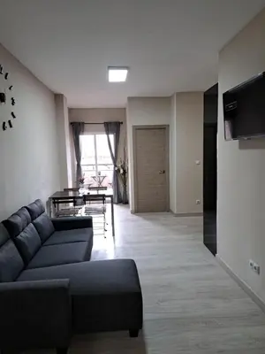a living room with a couch and a table at MERIDIANA sant andreu 4 bedrooms in Barcelona
