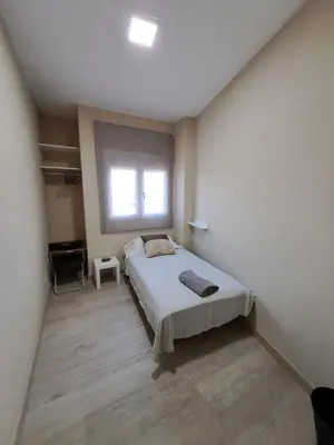 a bedroom with a bed and a window at MERIDIANA sant andreu 4 bedrooms in Barcelona