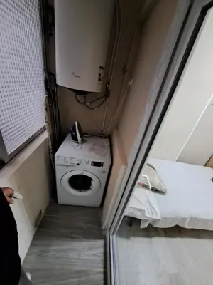 a small room with a washing machine and a bed at MERIDIANA sant andreu 4 bedrooms in Barcelona