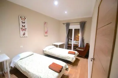 a hospital room with two beds and a door at MERIDIANA CLOT 4 bedrooms 2 bathrooms in Barcelona