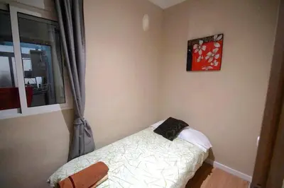 a bedroom with a bed and a window at MERIDIANA CLOT 4 bedrooms 2 bathrooms in Barcelona