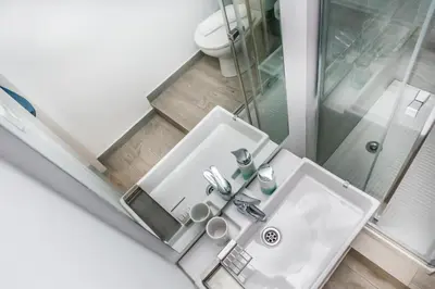 a bathroom with a white sink and a shower at Opening Doors Gràcia in Barcelona