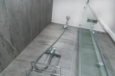 a glass shower in a bathroom with a glass floor at Opening Doors Gràcia in Barcelona