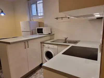 a small kitchen with a sink and a microwave at 2 bedrm BCN down AC WIFI 30 nigths min in Barcelona