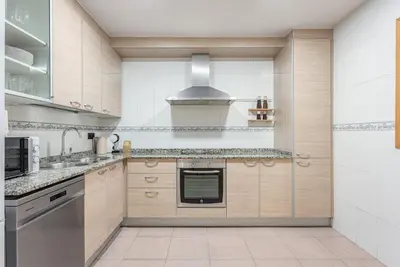 a kitchen with a sink and a stove at Ola Living Consell De Cent in Barcelona