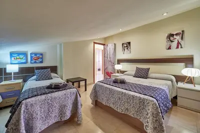 a hotel room with two beds in a room at Villa ilusions en Olivella, Sitges, Barcelona in Olivella