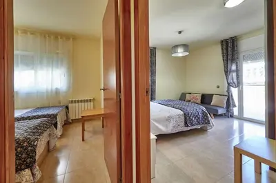 a hotel room with two beds and a couch at Villa ilusions en Olivella, Sitges, Barcelona in Olivella