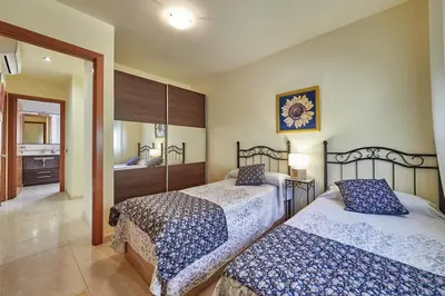 a bedroom with two beds and a bathroom at Villa ilusions en Olivella, Sitges, Barcelona in Olivella