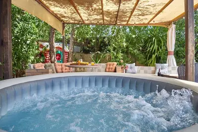 a hot tub in the middle of a patio at Villa ilusions en Olivella, Sitges, Barcelona in Olivella