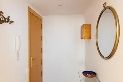 a mirror hanging on a wall next to a door at Housalia Gracia 2 in Barcelona
