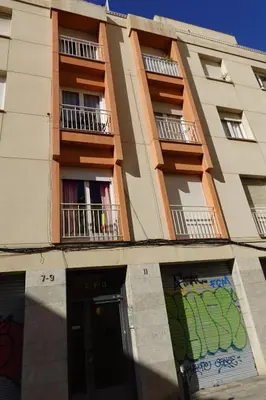 a building with balconies and a door in front of it at Housalia Gracia 2 in Barcelona