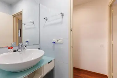 a bathroom with a white sink and a mirror at Housalia Gracia 2 in Barcelona