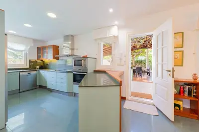 a kitchen with blue cabinets and a counter top at Casa Farré next Barcelona Center in Pallejá